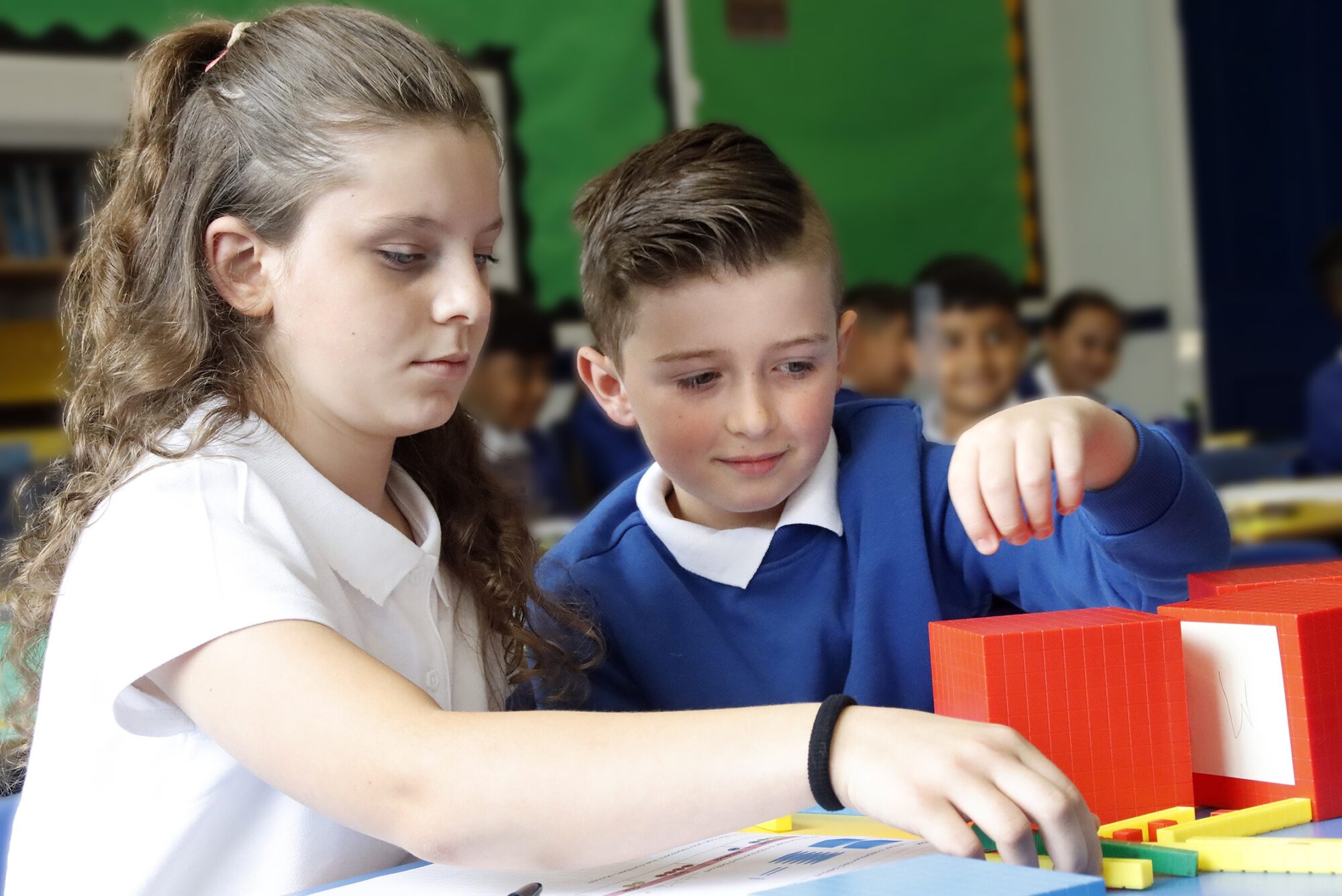Two children work on a colourful maths puzzle together