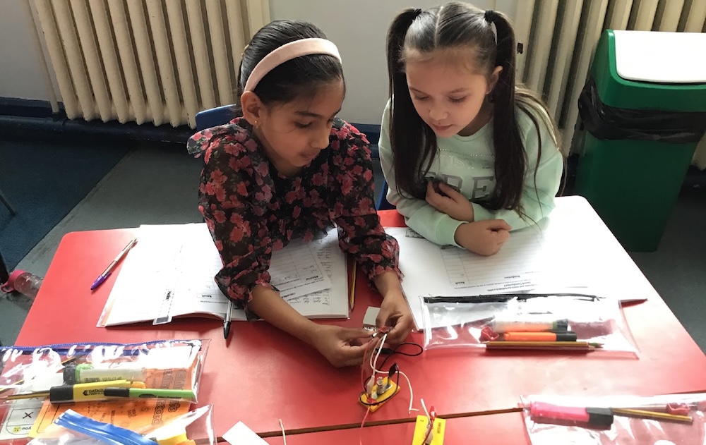 Two girls in science exploring circuits